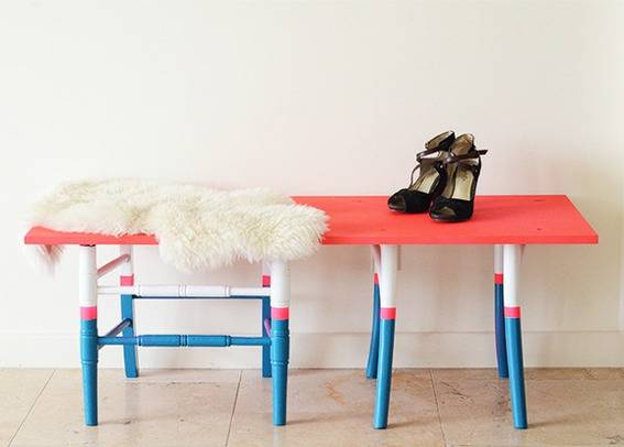Shoes sit on a red white and blue table with a matching chair.
