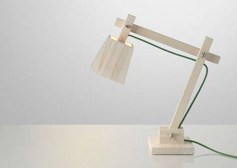 A wooden desk lamp with a green cord.