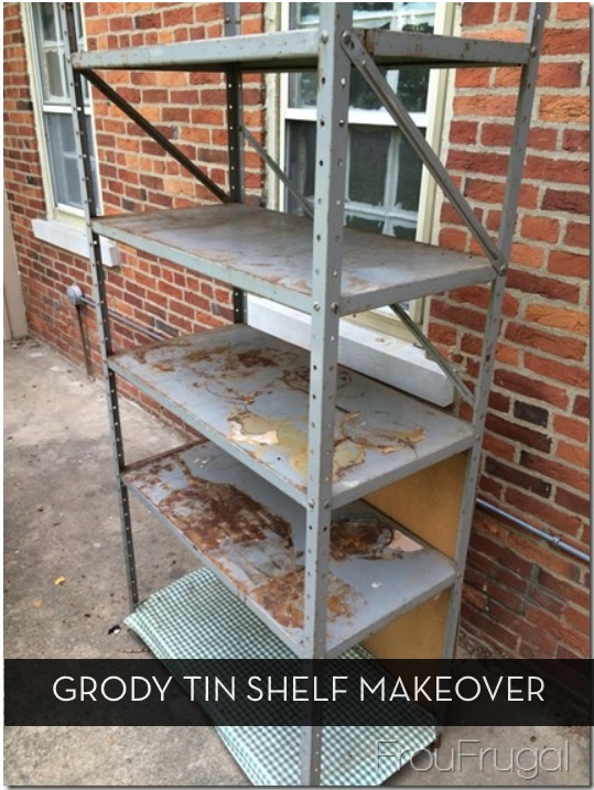 Rusted tin shelf with five levels sits outside a brick building.