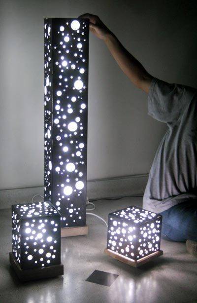 A person shows off lamps with bright white stars on black.