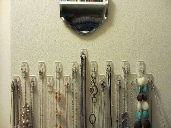 A list of necklaces in a white wall