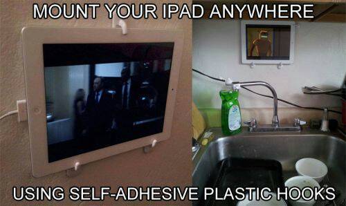 An ipad mounted to the wall in front of the kitchen.