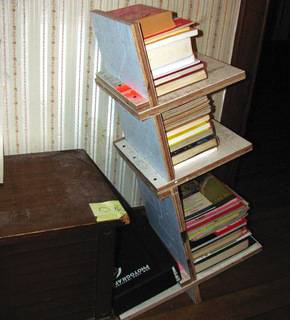 A bookshelf on its side full of books.