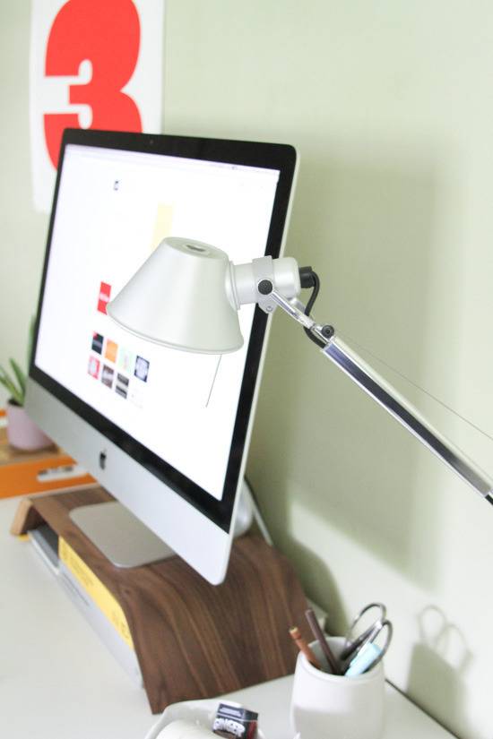 A Desk with Monitor, Stationary and Table Lamp"