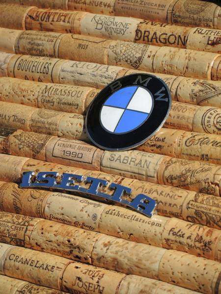A BMW and Isetta logo sitting on top of stylized wine corks.