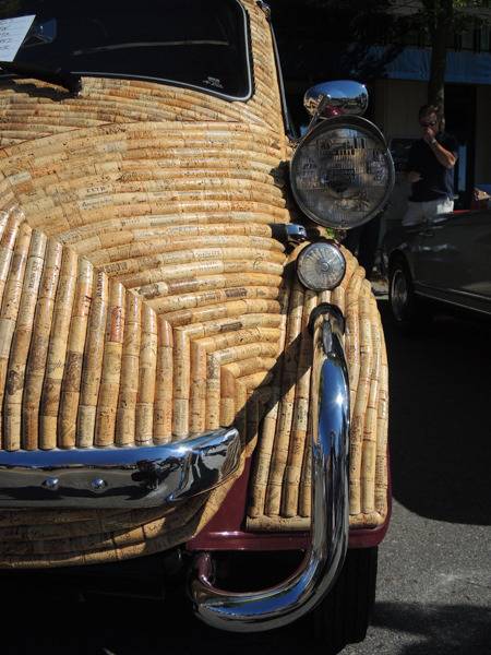 A small vehicle has the paint completely covered in corks as part of a cork covered car project.