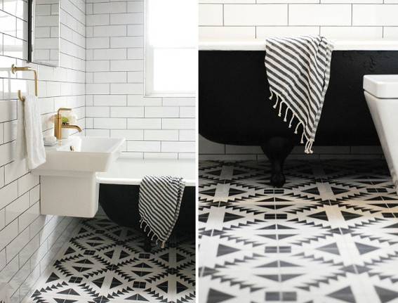 A bathroom has a black tub and white sink.