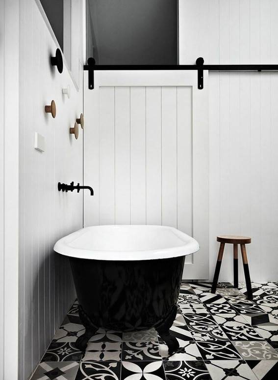 A black and white bathroom with a patterned floor tile.