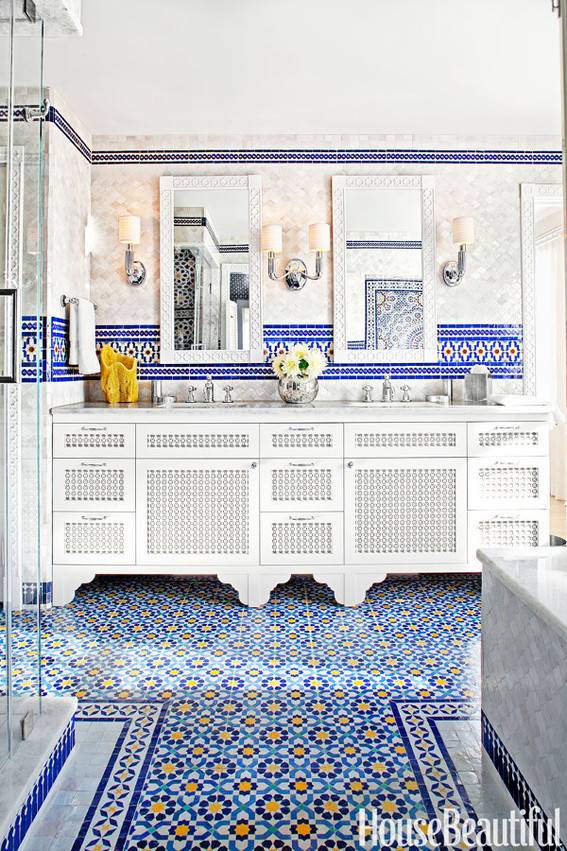 Exotic looking bathroom, with large white double sinks, and blue tiles.