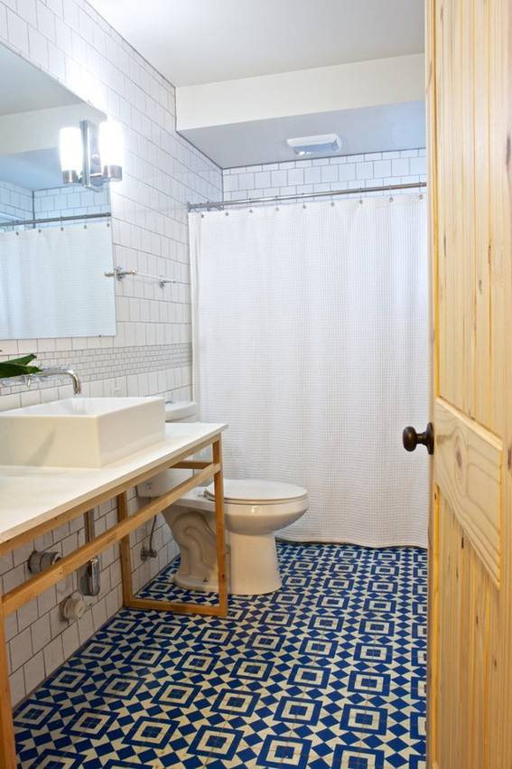 "Well organized modern bathroom with toilet and mirror."