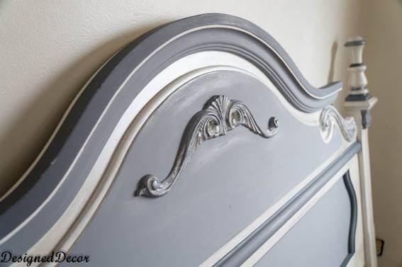 A blue-grey carved headboard.