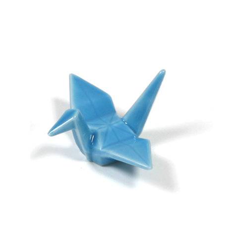 A small origami bird is light blue.