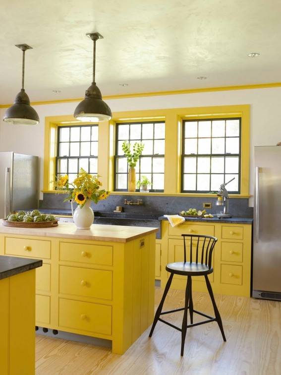 A modern kitchen has a yellow color scheme.