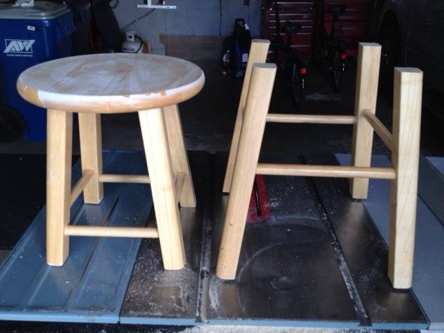 I wooden bar stool has been sawed in half to create two stools out of it.