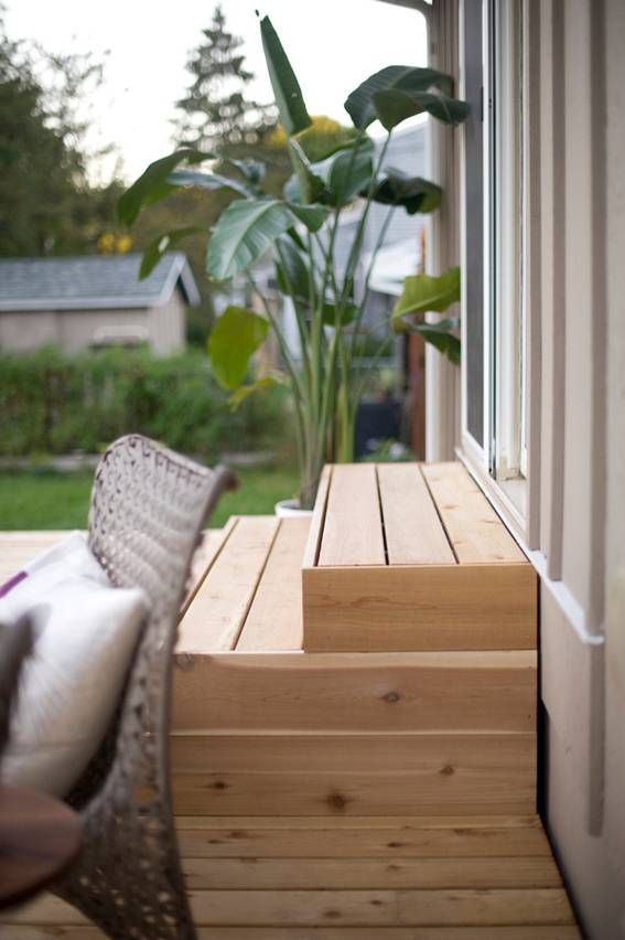 A pallet of wooden boards layered atop each other in a backyard area.