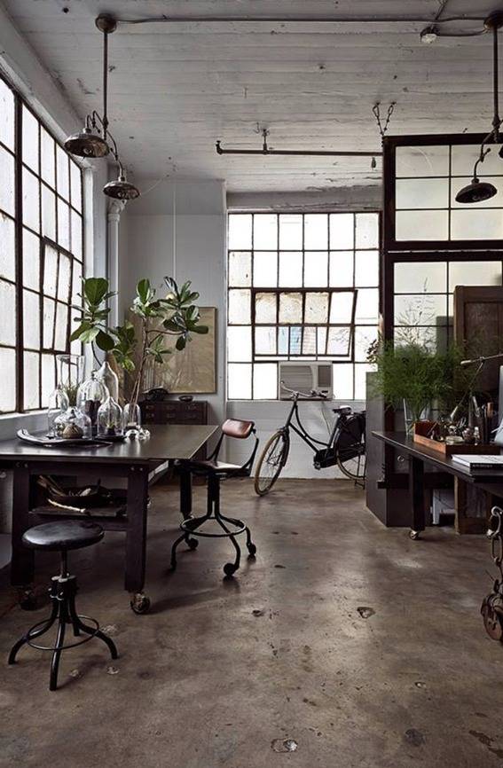 A room is well lit and has plants near a table.