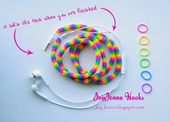 Colorful wired headphones are rolled up on a white table.