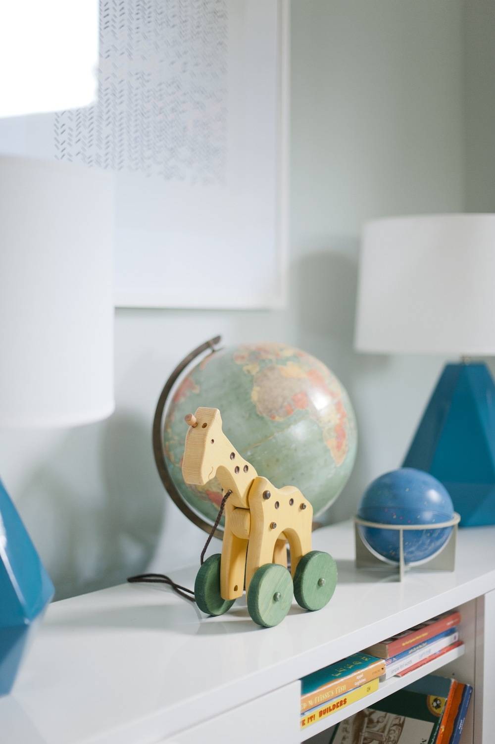 A shelf has children’s decorations on top of it.