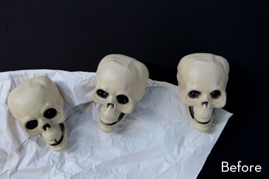 Three toy skulls on top of a white towel.