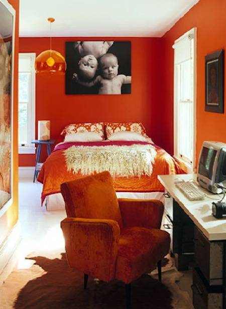 A crimson bedroom has a white floor.