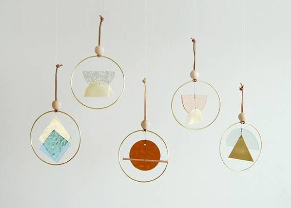 Five dream catchers are hanging off the wall.