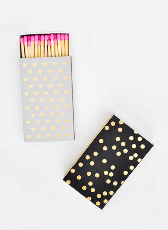 Matches are in a grey and gold polka dot box, and a black and gold polka dotted box.