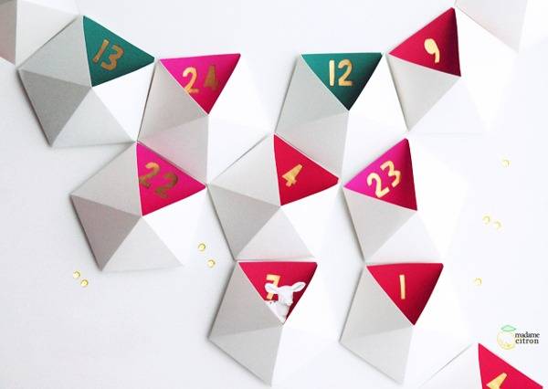 White, pink & green decor hang on a white wall.