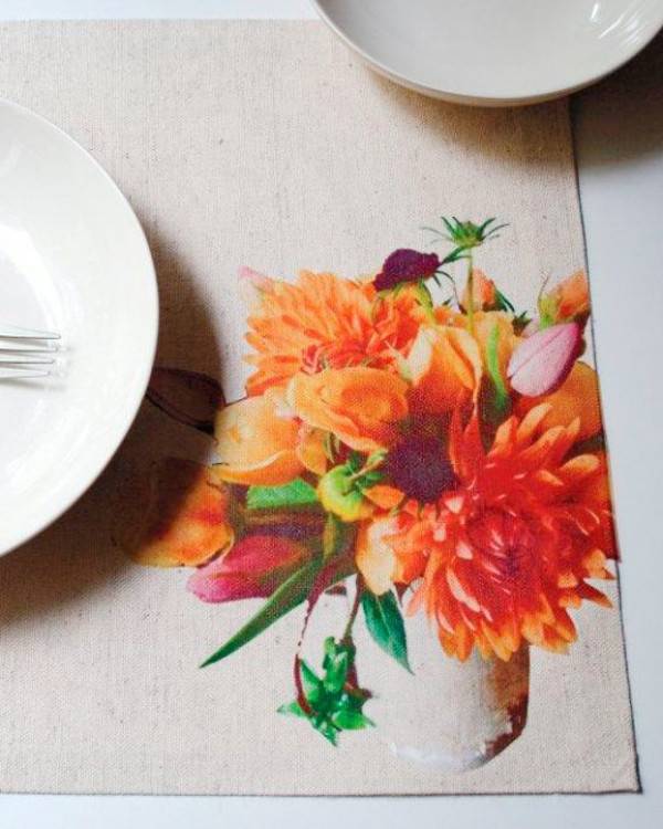 Flowers decorate a napkin under plates.