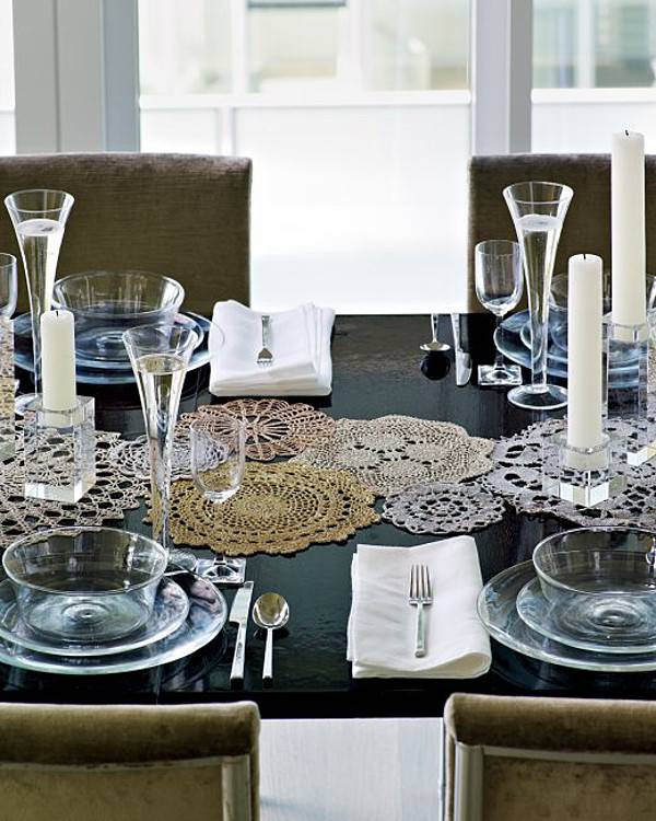 A black table with place settings and dishes.