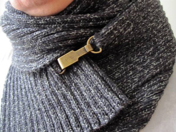 A scarf has a clasp on it.