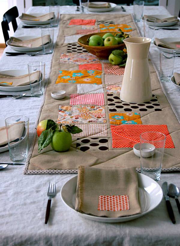 Dinning table with plates, forks, napkins, glasses, fruits arranged in an order.