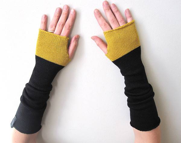 two hands with knitted wraps