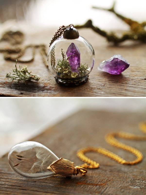 Glass pendant with purple crystal and greenery within.