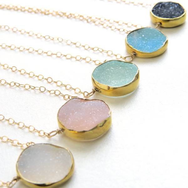 Five gold pendants with colored glass in round gold circles.