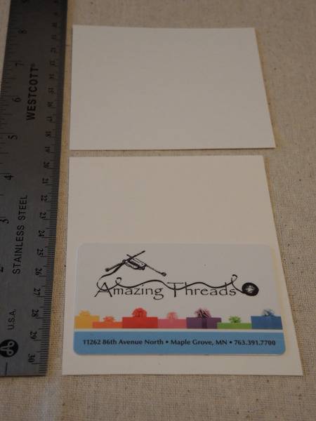 A ruler and items for putting together a fabric envelope.