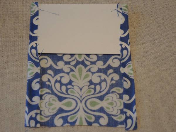 Cardboard is placing in a printed fabric cloth.