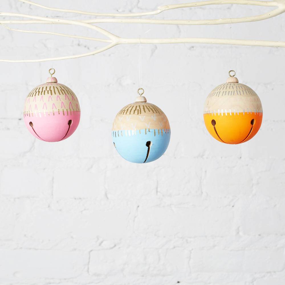 Three colorful smiley hangings hanged to rods.