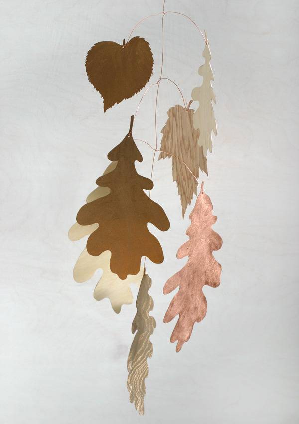 Different types of veneer cut leaves hanging with a copper wire to a wire stem.