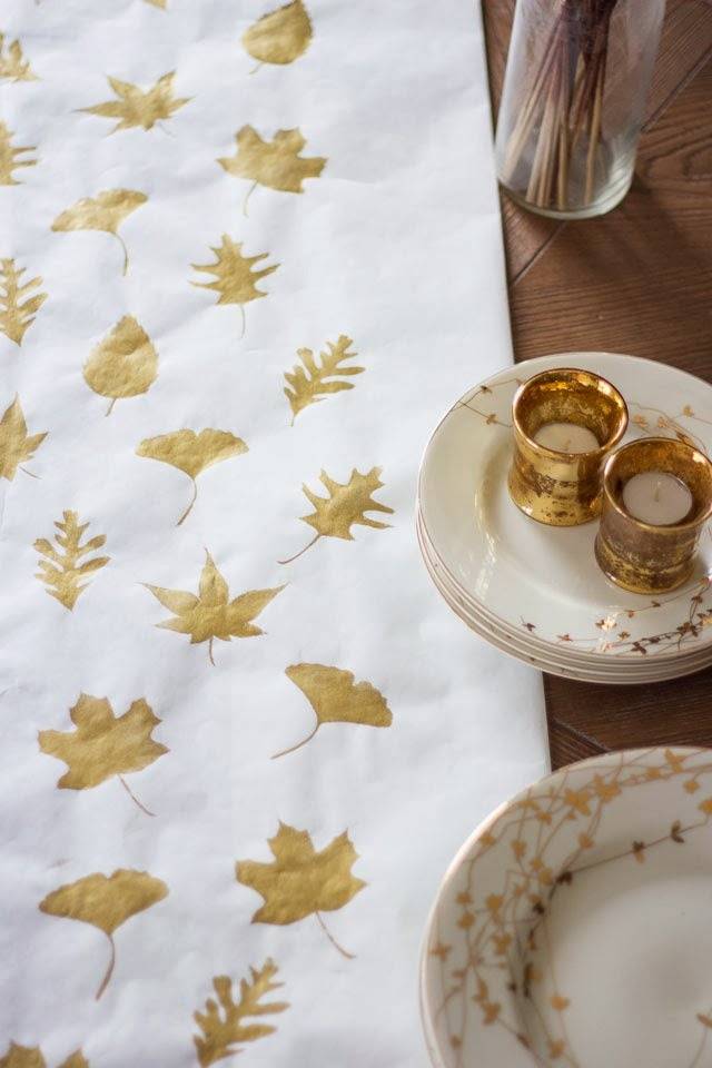 Gold leaves are printed on the white material.