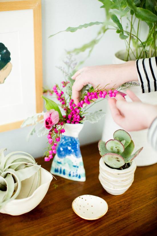 "Tea cup plant and flowers on the table."