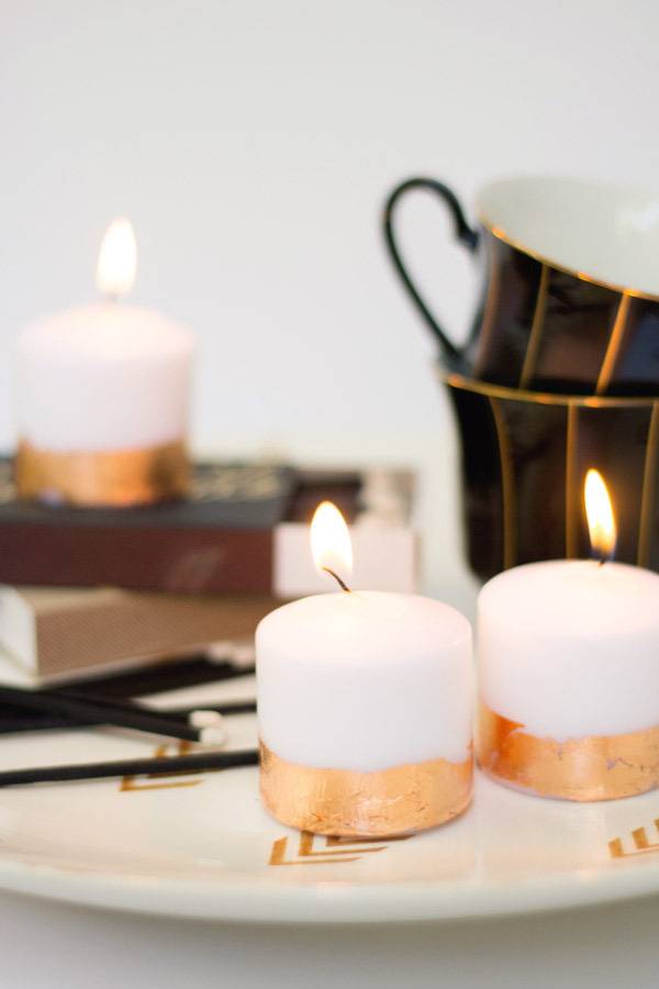 Votive candles near brown cups.