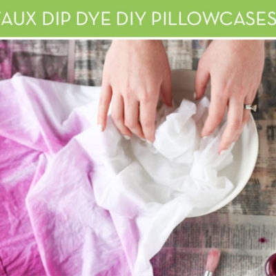 Hands demonstrating fabric being dip dyed for a purple ombre look.