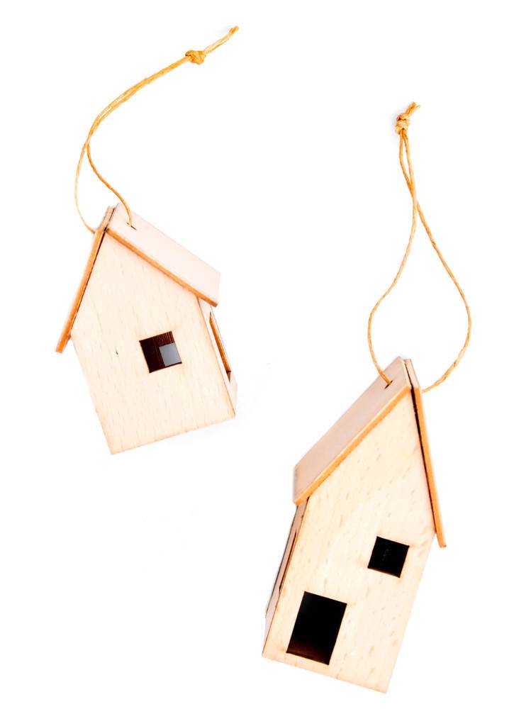 Two model houses are hanging from strings.