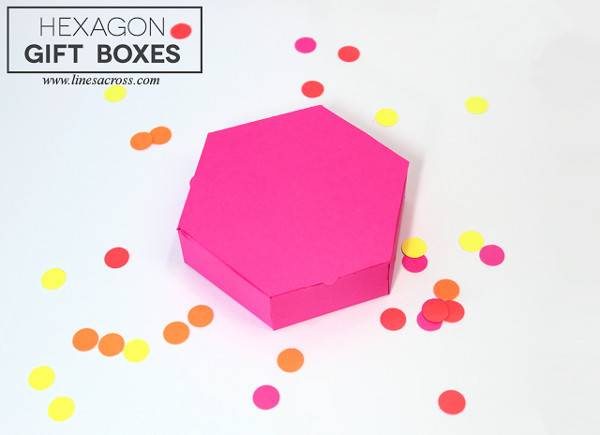 A pink hexagon gift box surrounded by dots.