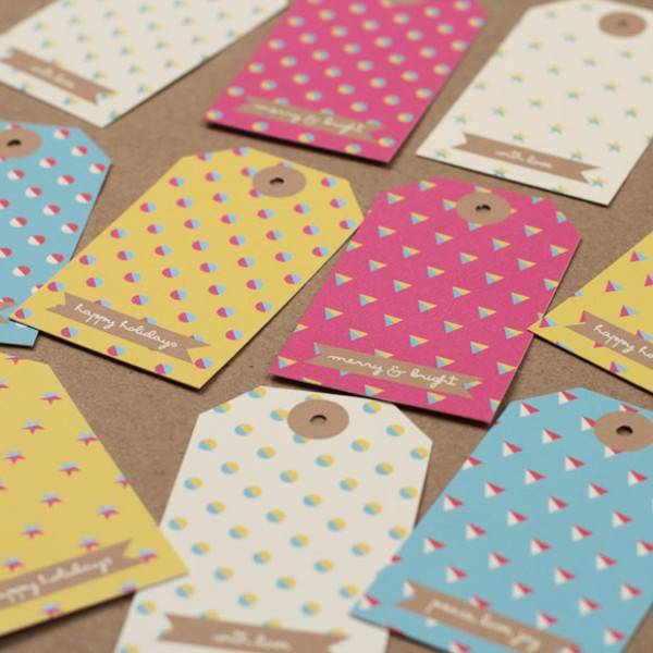 Christmas-themed, holiday gift tags in various colors/patterns assembled.