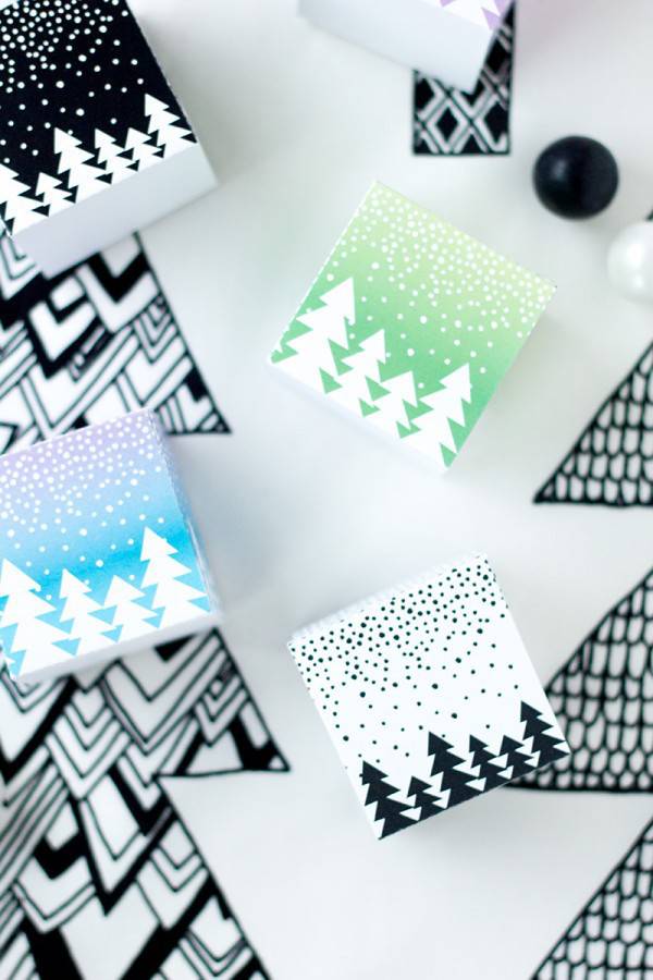 Several white pieces of paper with Christmas tree designs on them.
