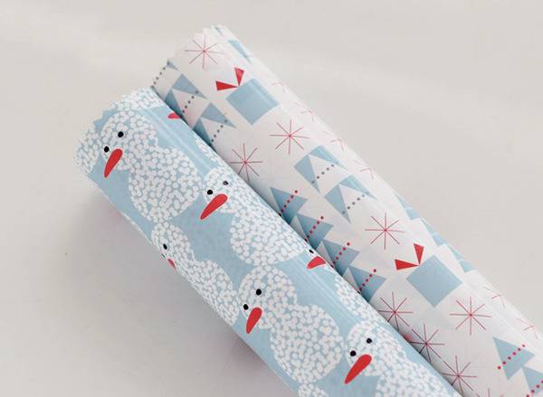 Two rolls of wrapping paper, stylized in a snowman, Christmas art design.