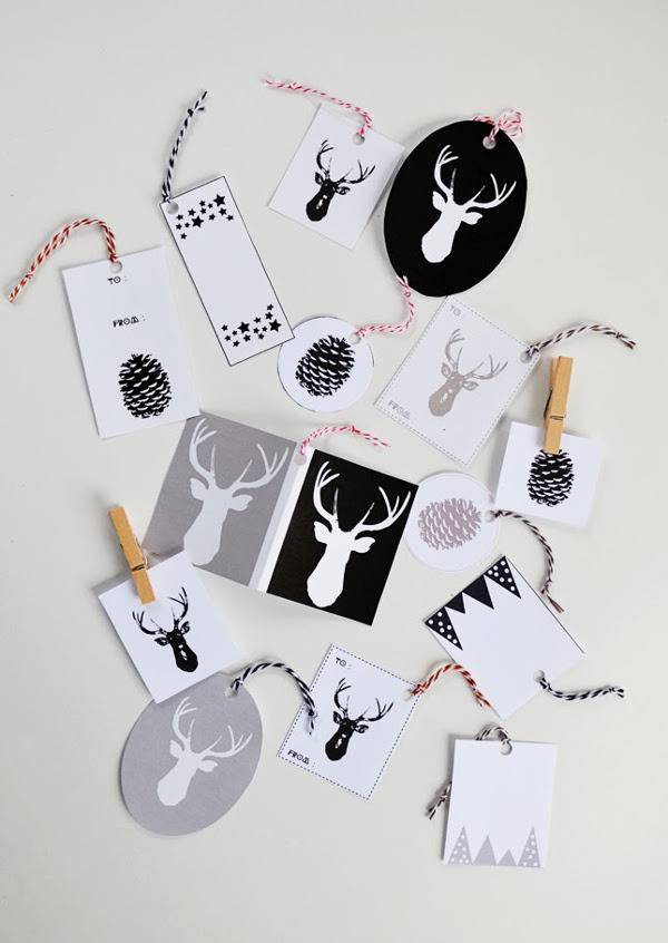 Holiday gift tags featuring images of deer and pinecones.