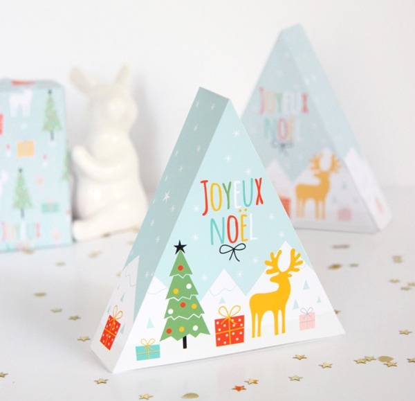 Triangular block of wood painted with light blue white with Christmas tree and reindeer.