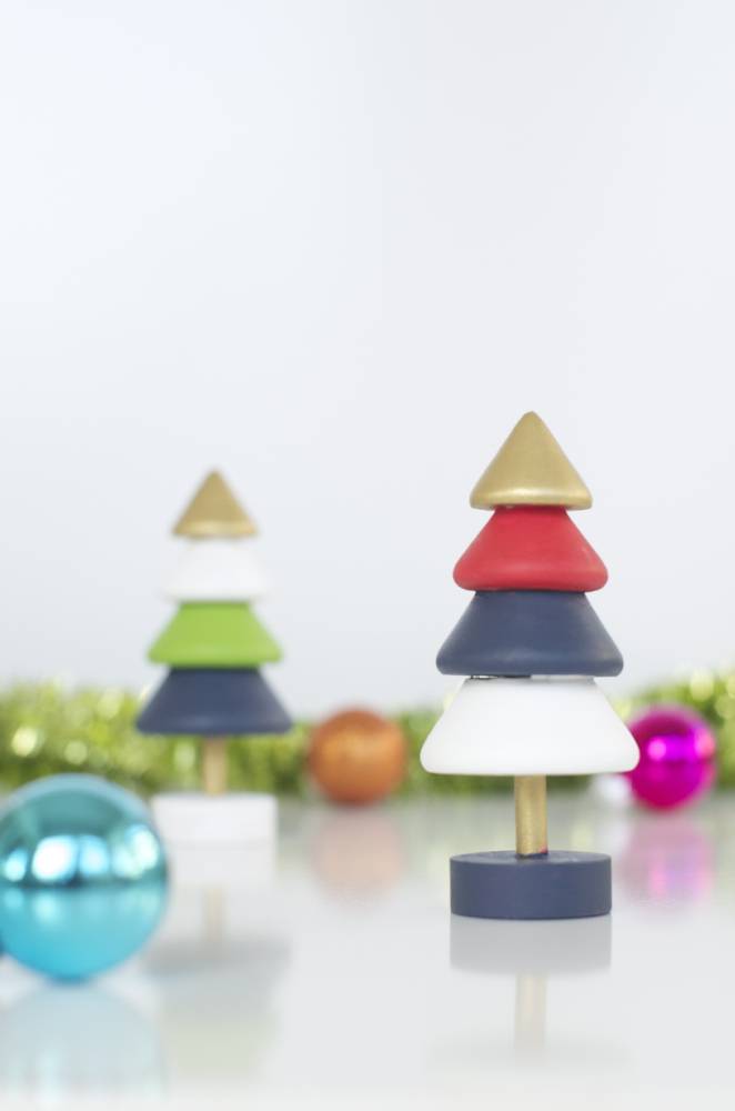 A sculpture of colorful Christmas trees and a blue ornament.